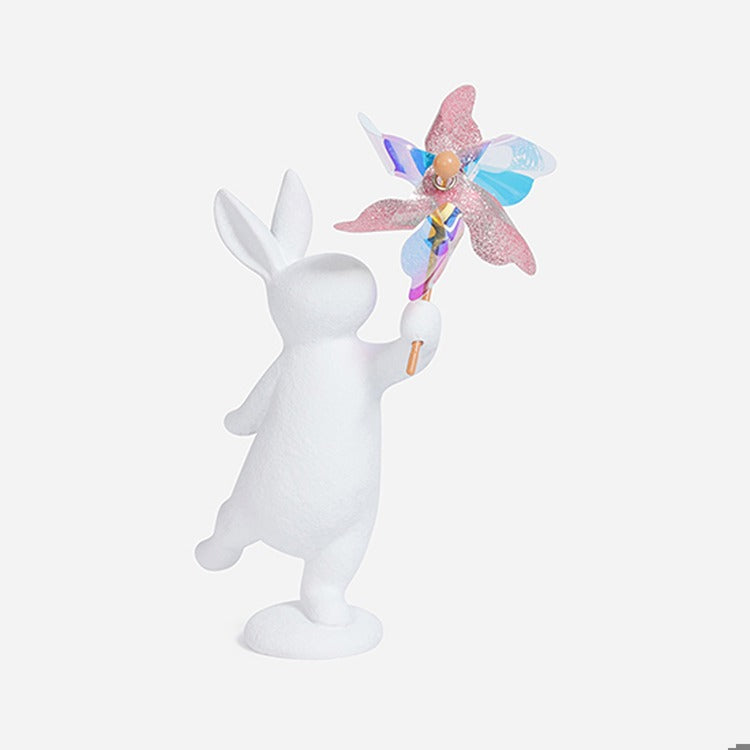 7.75" Resin Bunny Holding Iridescent Pinwheel